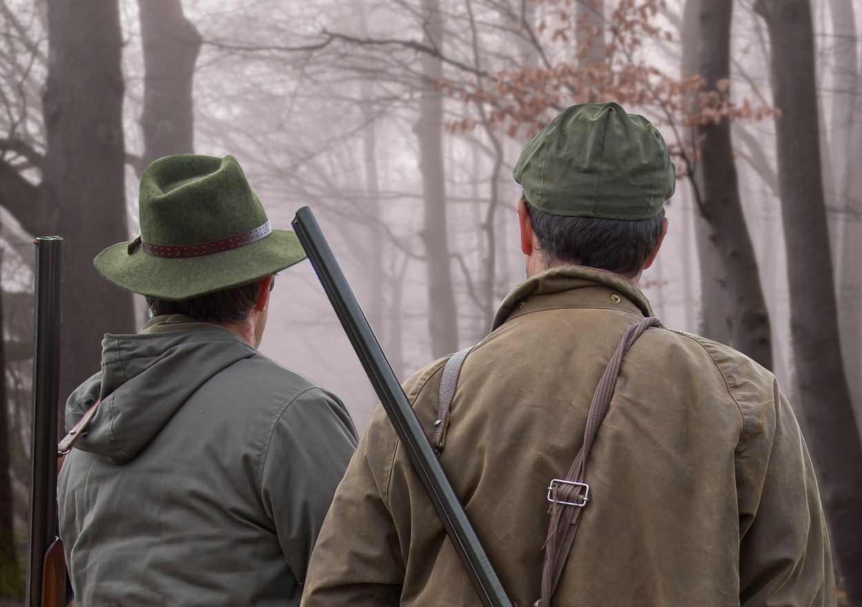 Zwei Jäger mit klassischem Jagdhut und Schirmmütze